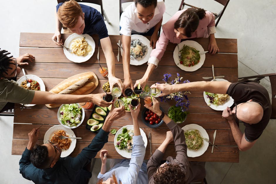 A family serving shared dishes at a dinner table.