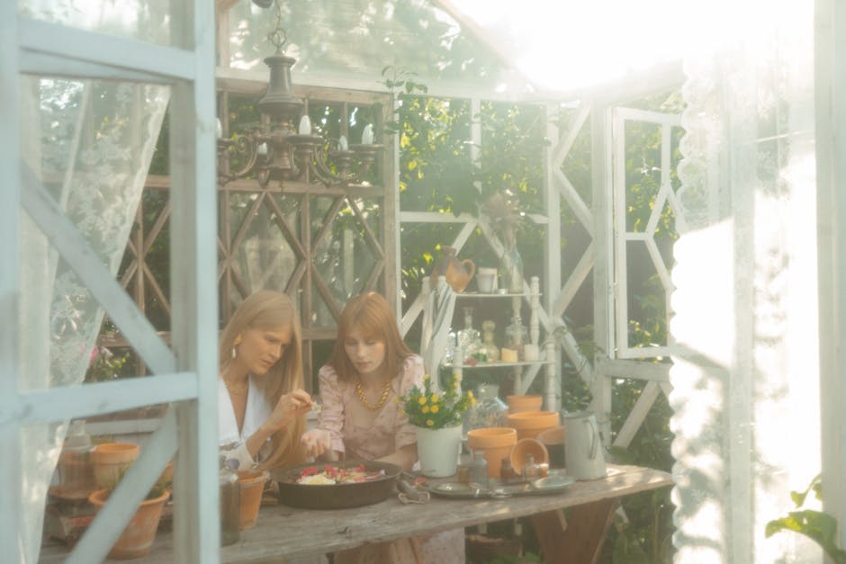 Outdoor table set with farm-fresh dishes overlooking a field.