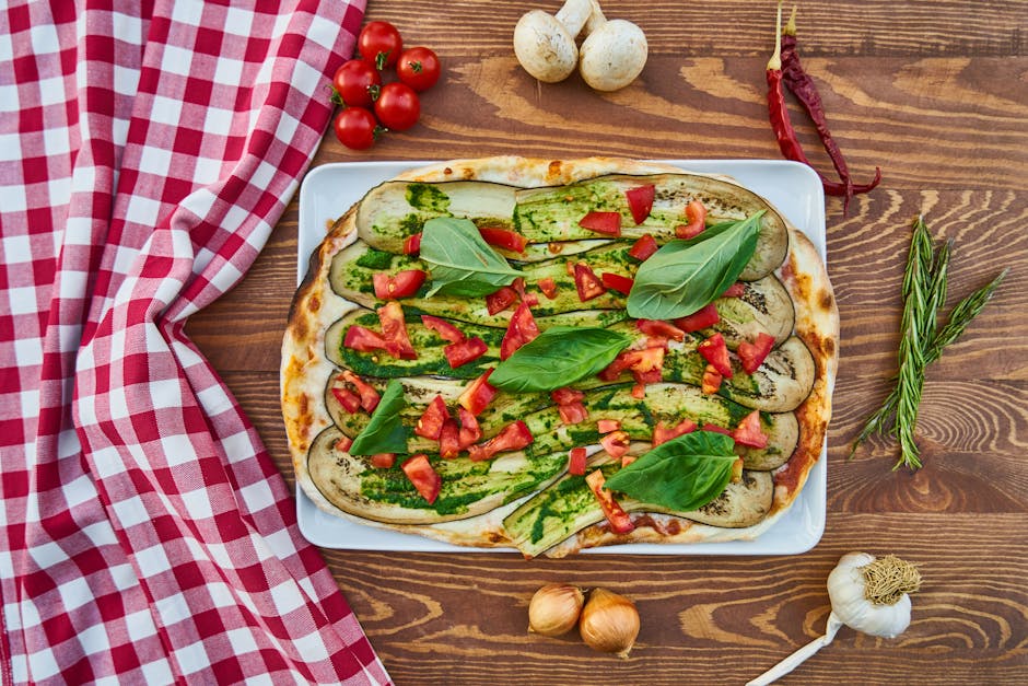 Bowls of roasted vegetables and grains arranged family style on a wooden table.