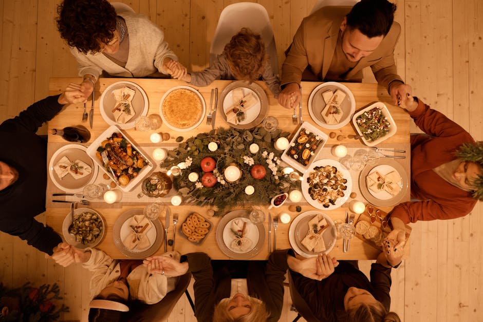 Festive holiday table with roast, sides, and candles.