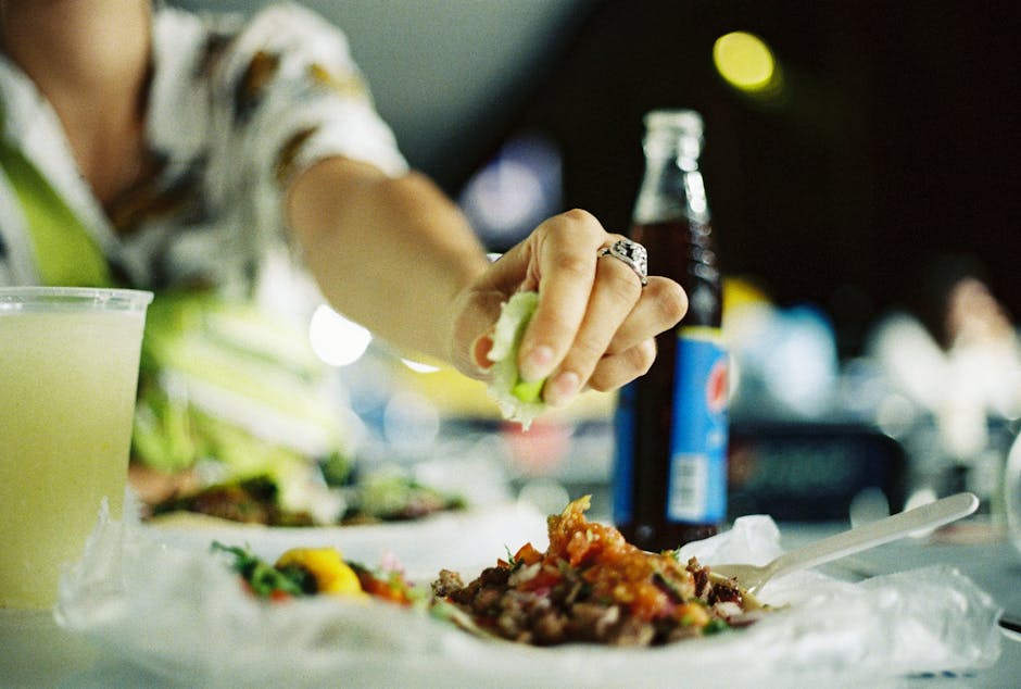 Authentic Mexican street tacos with fresh toppings and lime wedges.