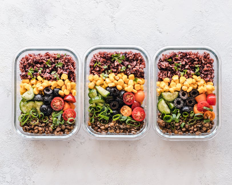 Containers filled with plant-based meal prep ingredients.