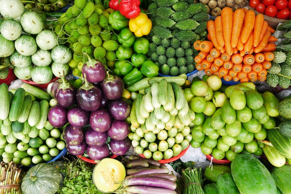 Baskets of seasonal vegetables and fruits at an outdoor farmers market.