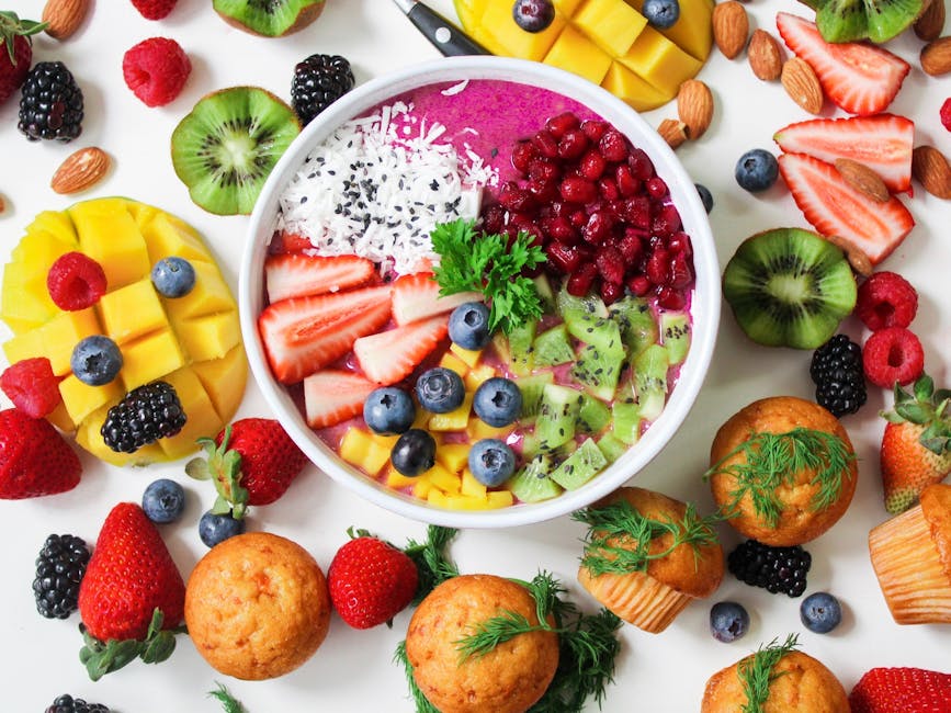 Assorted vibrant smoothies topped with fruit and seeds.