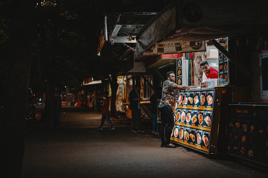 Vibrant street food stall serving dishes at a night market.