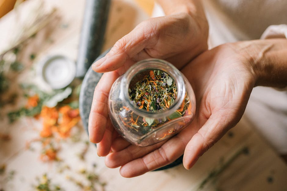 Loose tea leaves, herbs, and spices arranged for blending.