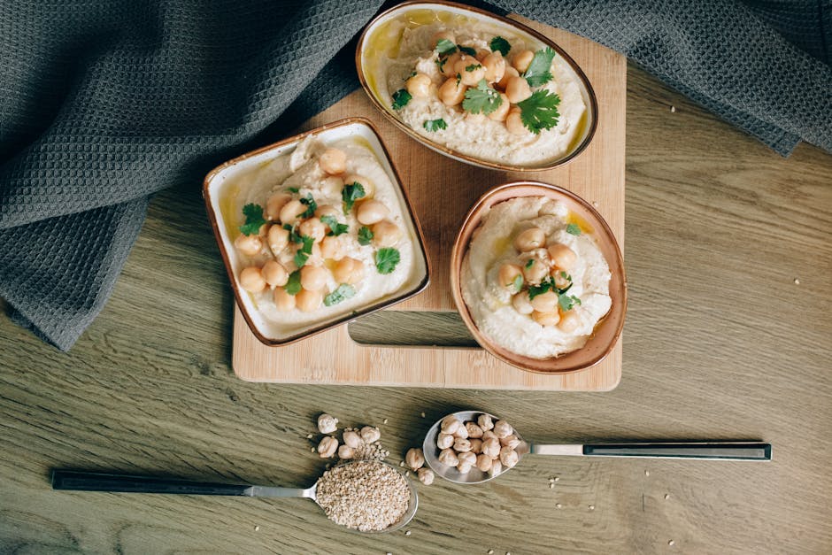 Plant-based dishes including roasted vegetables, grains, and dips set on a table.