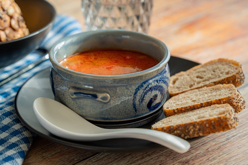 Steaming bowls of hearty winter soups with crusty bread.